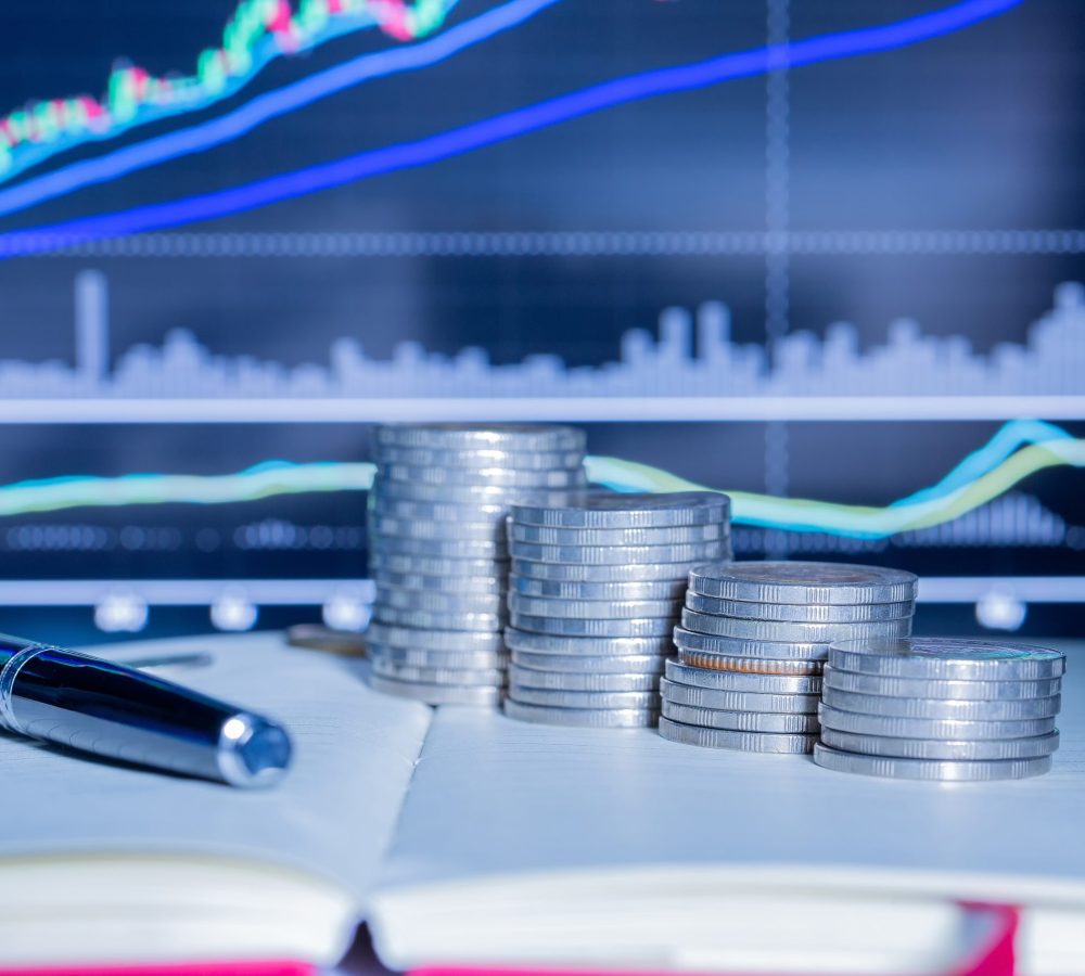 Stack of money coin with trading graph. financial investment concept use for background.